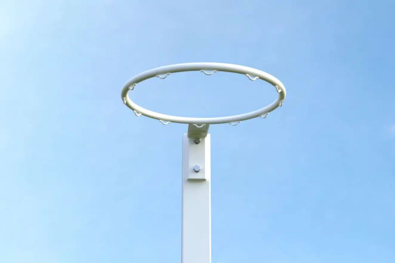 NBES-R1 - RMA Sport White basketball hoop ring mounted on a pole against a clear blue sky.