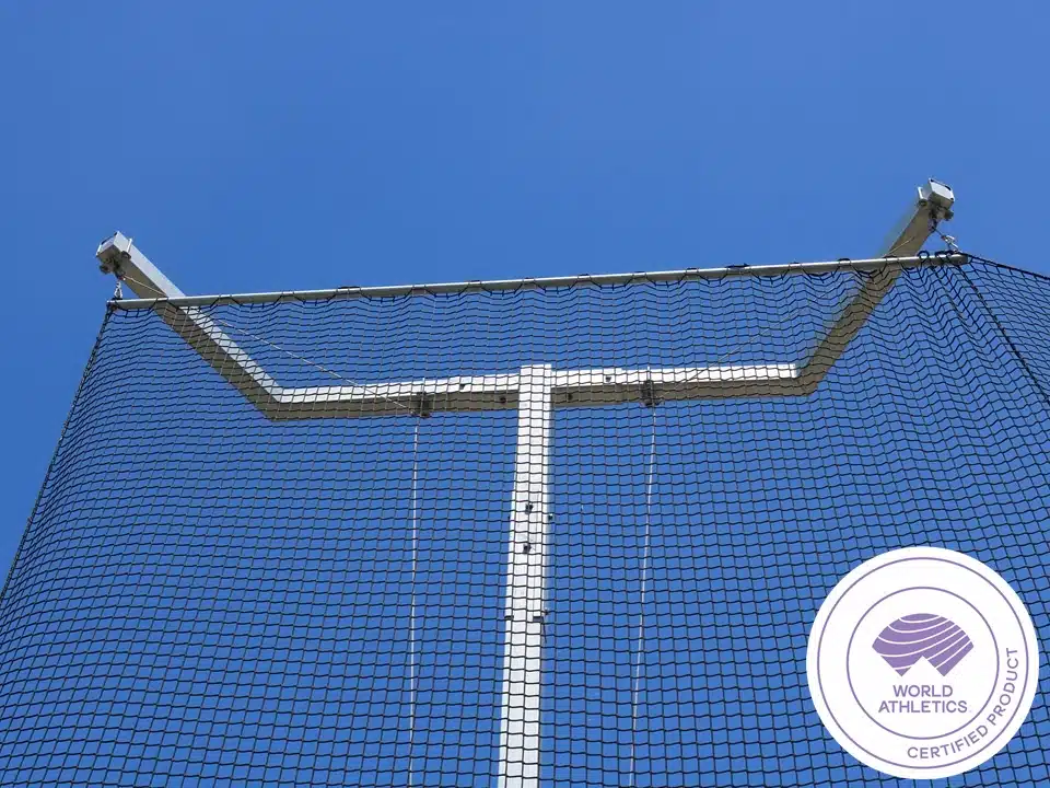 ATH-DTC64 - world-athletics-certified-competition-discus-throw-cage-3 - RMA Sport Blue sky behind a white metal U-shaped goalpost frame with netting, likely a sports boundary or backstop.