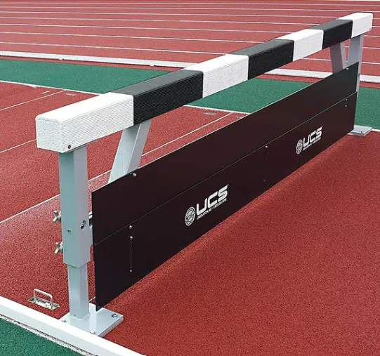Water Jump 1 - RMA Sport Athletic hurdle on a red running track, with a white cushioned top bar and a black panel featuring UCS logos.