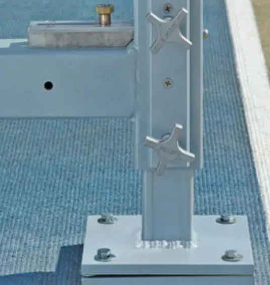 Water Jump 2 - RMA Sport Close-up of a metal post with two wing nuts attached to a square base plate bolted to a blue textured surface.