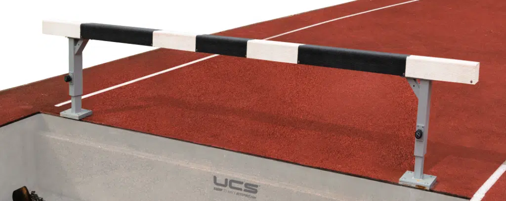 Water Jump 5 - RMA Sport Adjustable high jump crossbar supported by two metal stands over a red track surface and landing pit